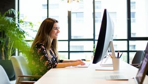 a female event coordinator working at a computer in a beautiful office-1